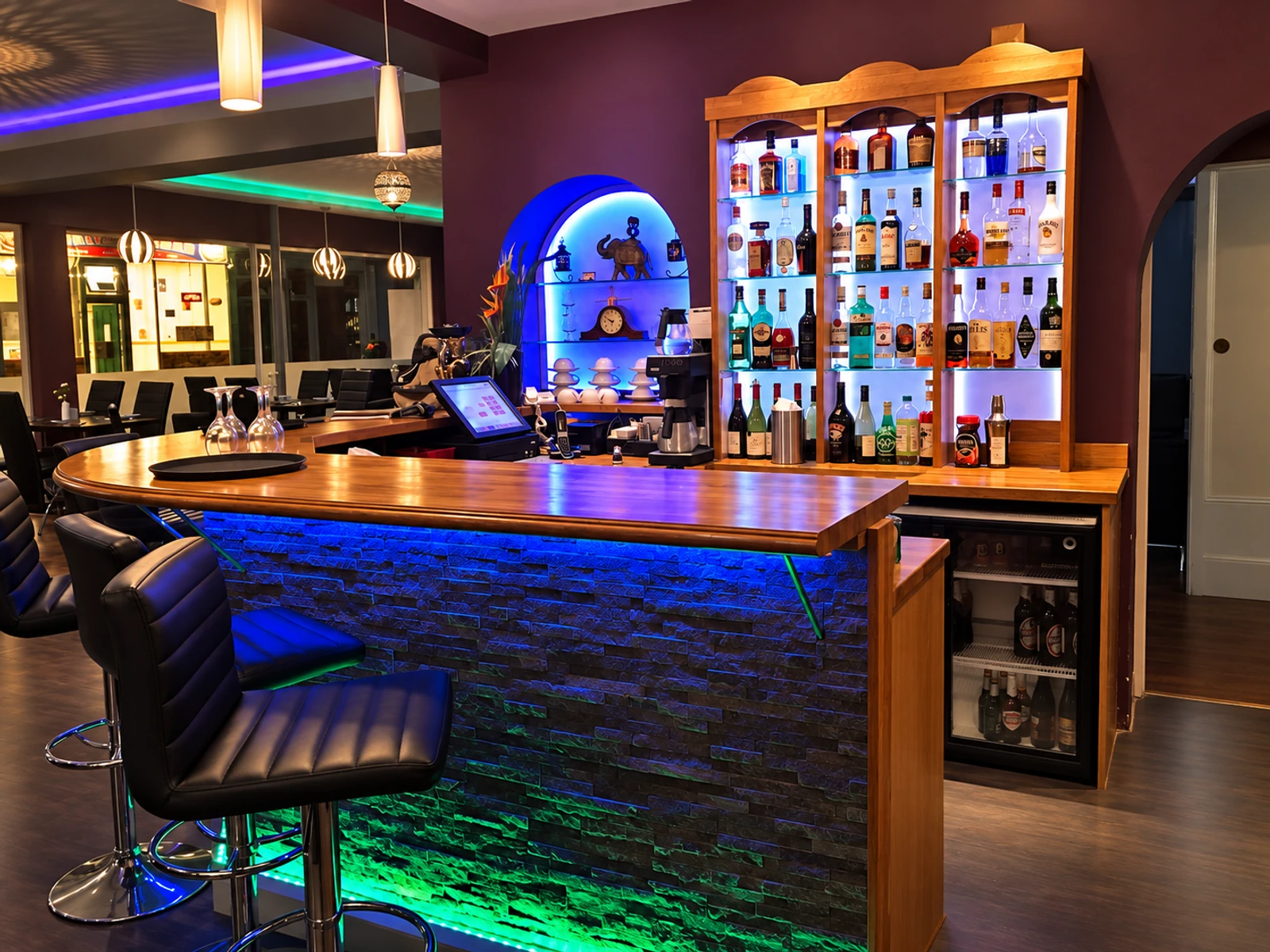 The illuminated bar and drinks display at Masala Bay