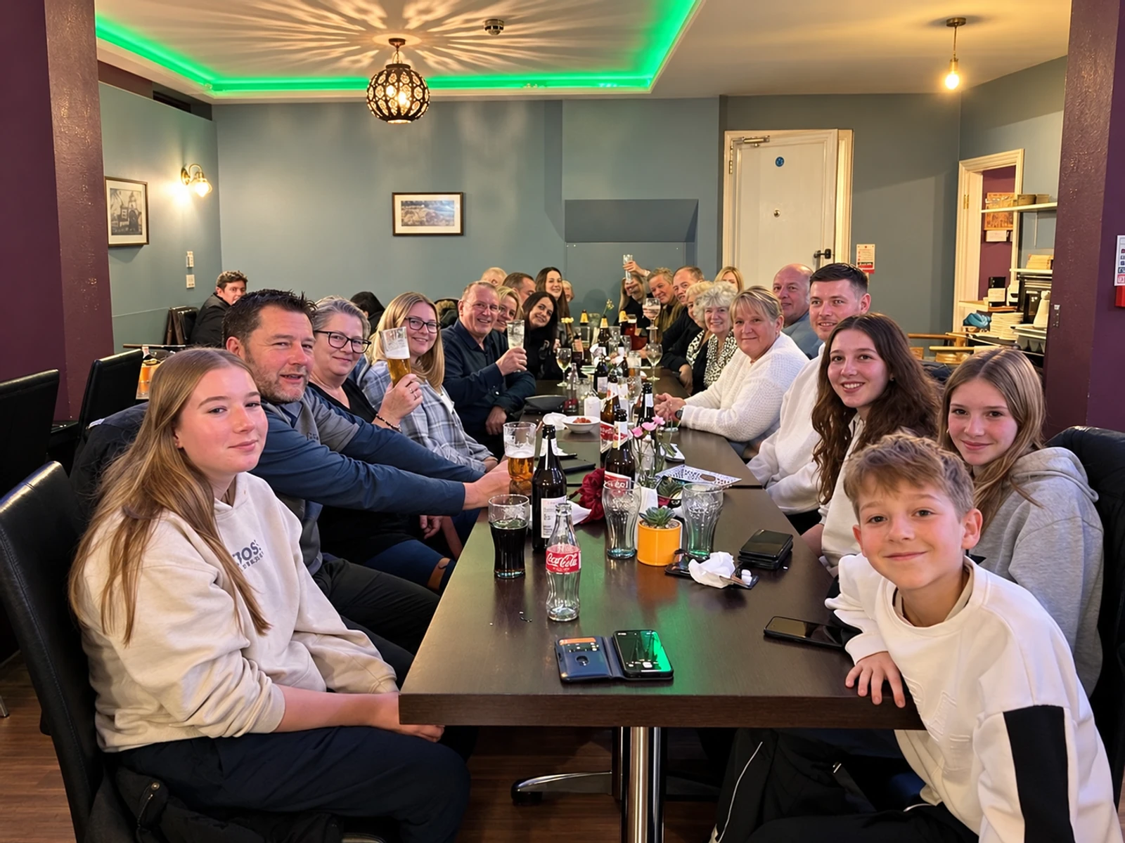 Family and friends gathered around a long table at Masala Bay