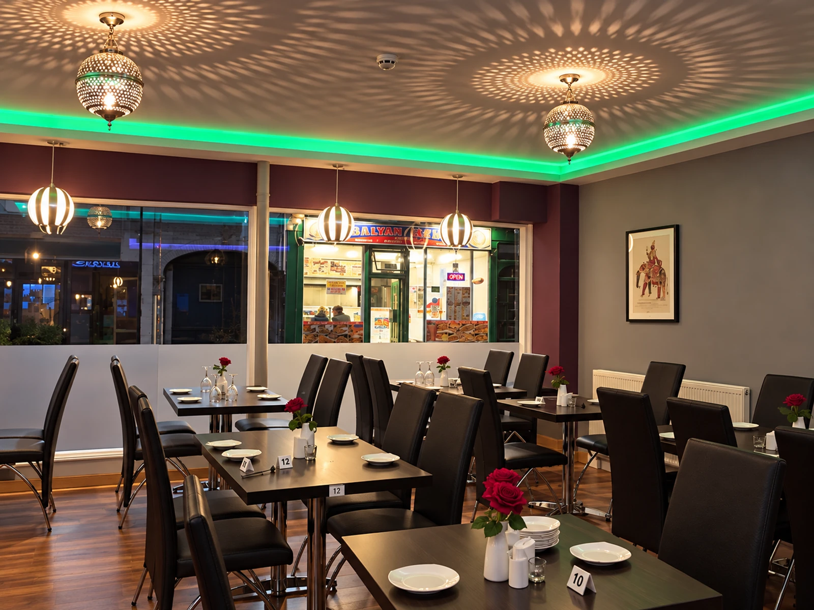 A warmly lit Masala Bay dining room with tables set for the evening