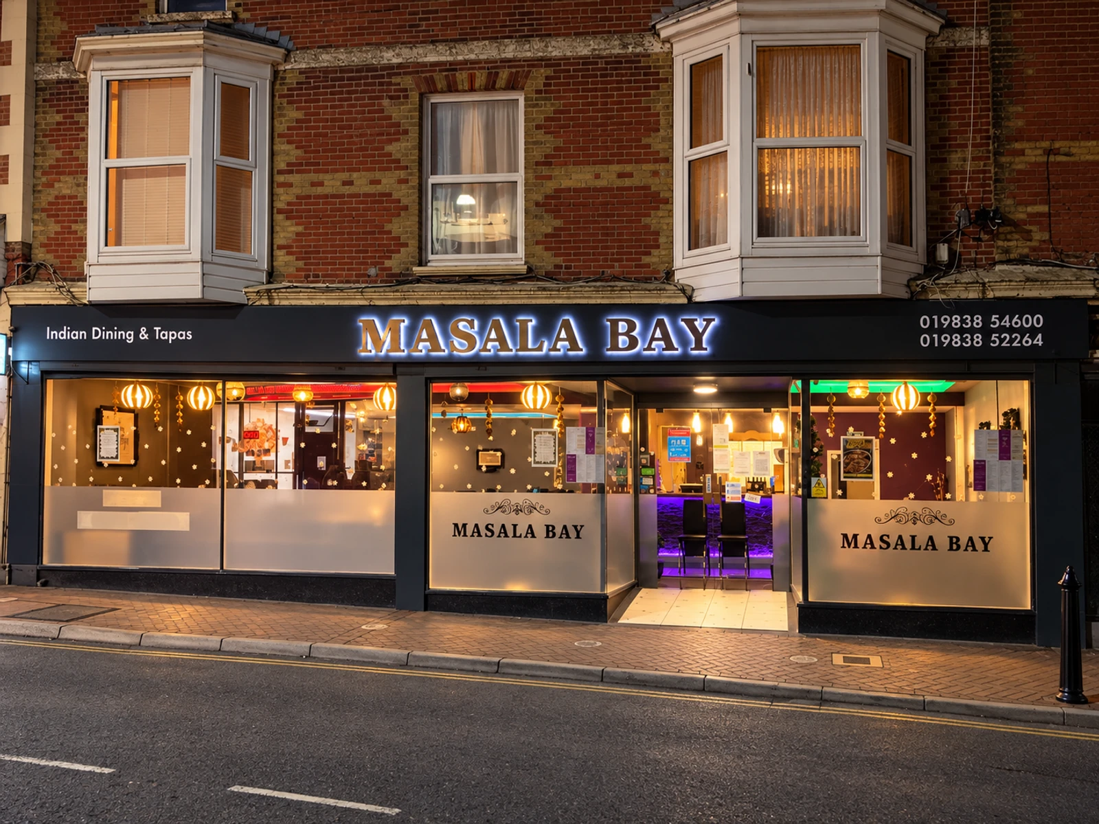 Masala Bay’s illuminated shopfront at 9–11 Pier Street, Ventnor