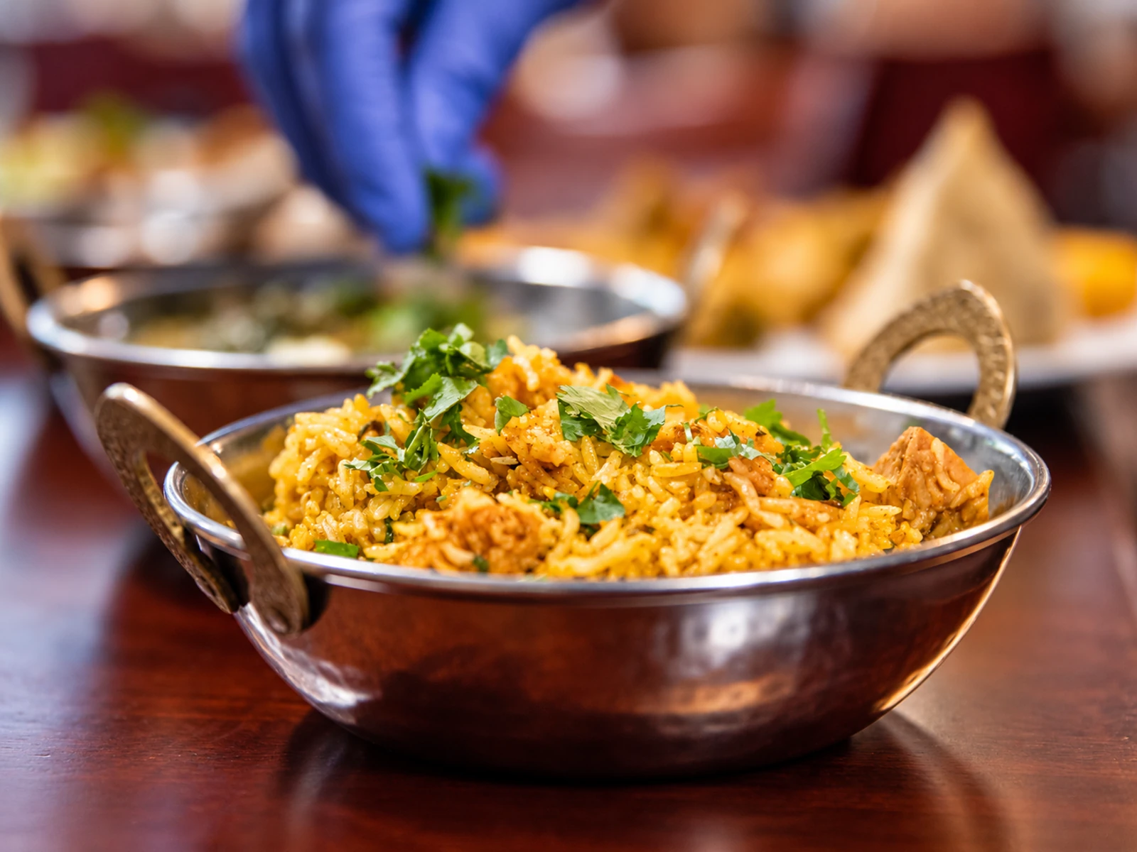 Golden biryani rice with chicken and fresh herbs